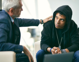 anxious man comforted by his doctor