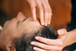 woman having hair treatment for lice