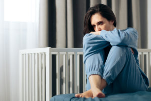 anxious woman staying in her bedroom